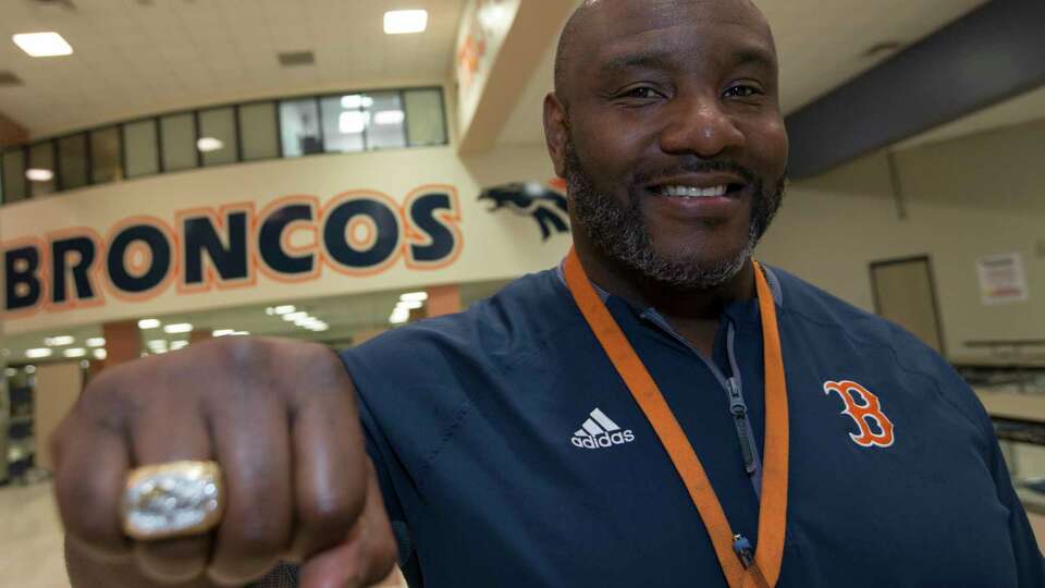 Fort Bend George Bush High School Football Coach Allen Aldridge shows this his Super Bowl XXXII ring while posing for a photograph on Thursday, Jan. 31, 2019, in Richmond. Aldridge played middle linebacker for the Denver Broncos when the team defeated Green Bay Packers in 1998.