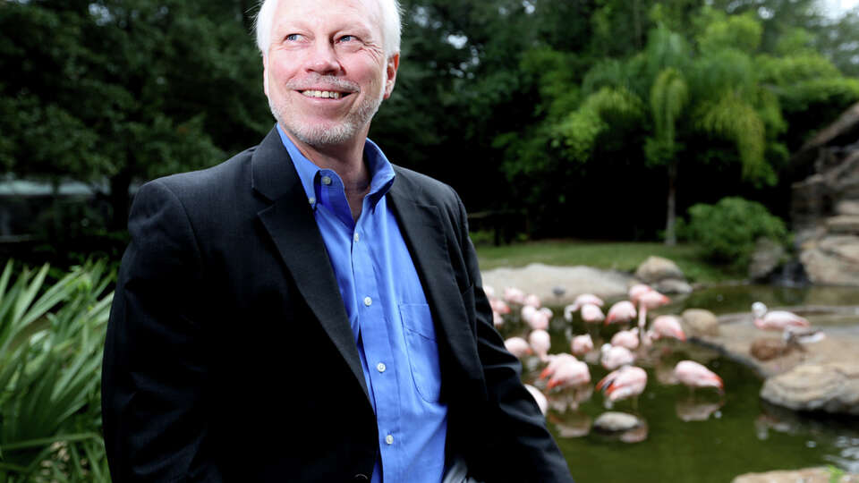 Houston Zoo's new director, Lee Ehmke, sits near the flamingo exhibit at the zoo in Houston.