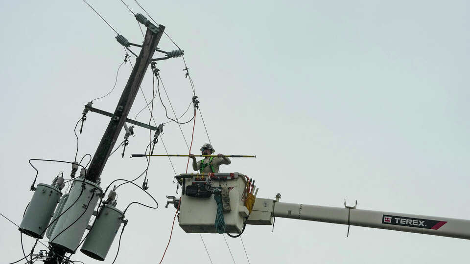 A lineman tends to fallen power lines in the East End neighborhood of Houston, days after Hurricane Beryl made landfall, on Thursday, July 11, 2024 in Houston.