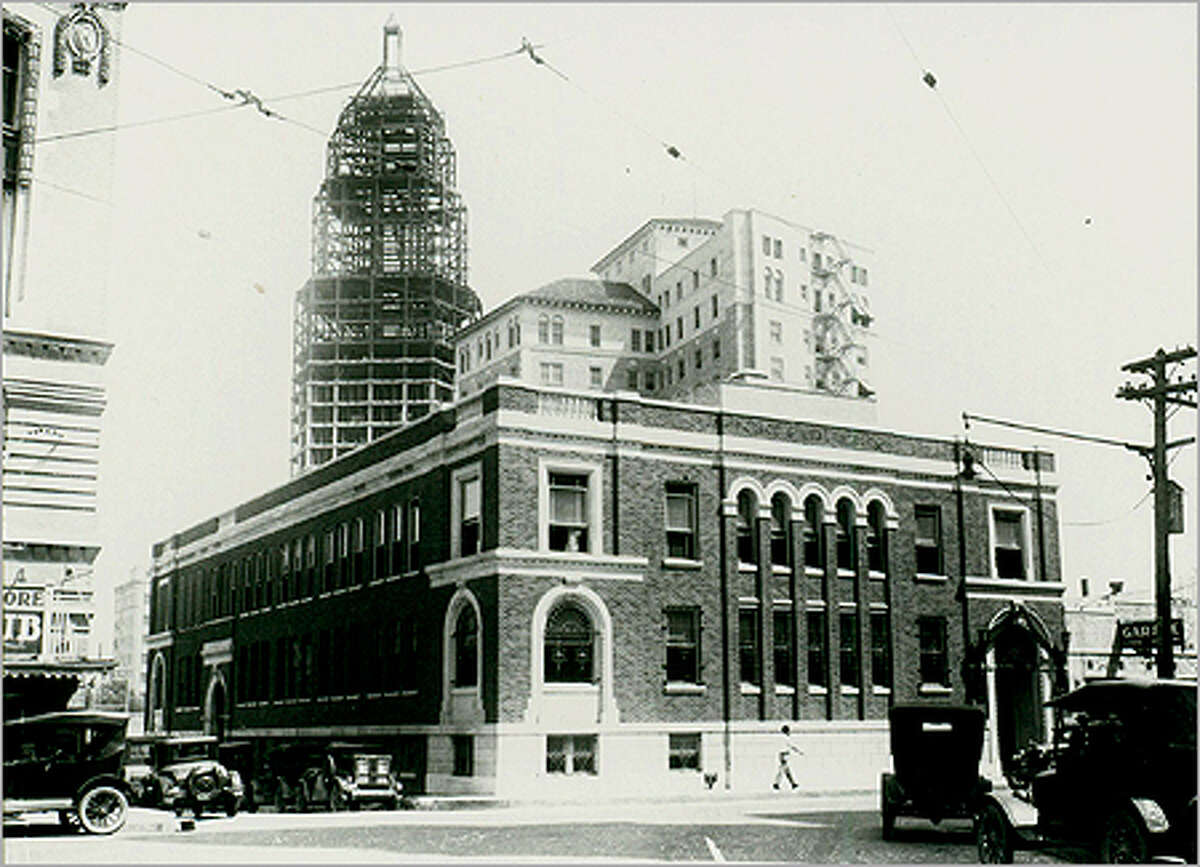 The Tower Life Building, shown under construction in the background, was constructed by brothers Albert and Jim Smith, owner of Smith Bros. Properties.