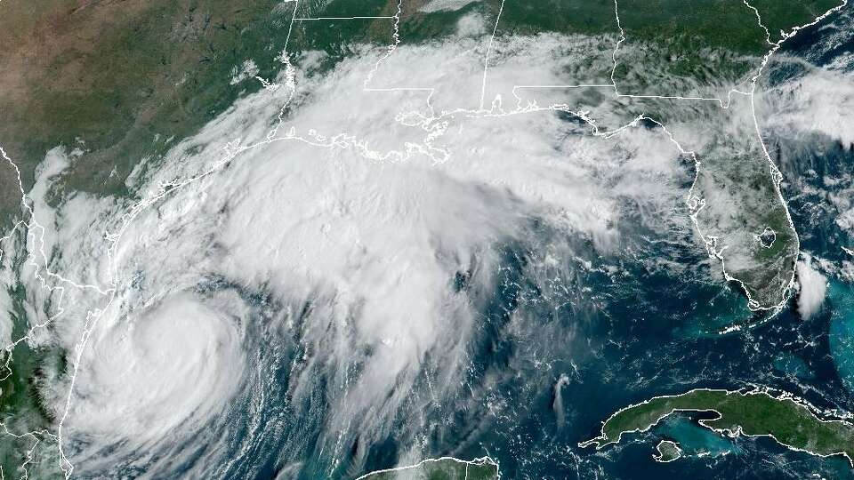 In this weather satellite image taken Tuesday morning, Tropical Storm Francine was spinning in the southwestern Gulf of Mexico, lower left. The storm was expected to come ashore in southern Louisiana on Wednesday.