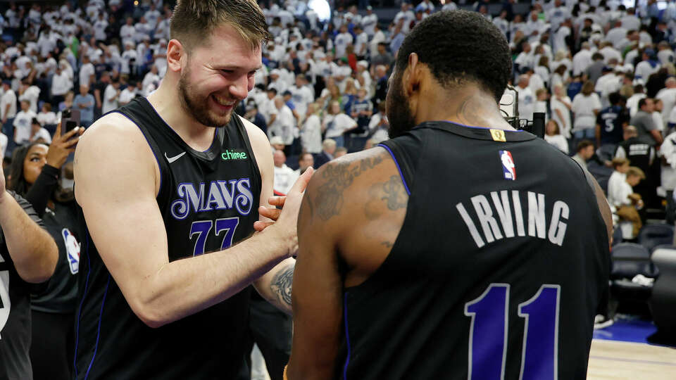 Luka Doncic celebrates with Kyrie Irving after the Mavericks beat Minnesota in Game 2 of the Western Conference Finals last season. A potential foul on Irving late in the game was not called even though it was seen on a replay review. NBA rules didn't allow it to be called.