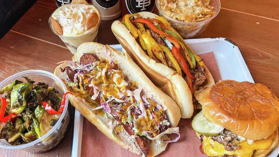 Truth Slaw Dog, Brisket Philly and Brisket Burger from Truth Barbeque's bar bites menu