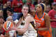 Connecticut Sun guard DiJonai Carrington (21) fouls Indiana Fever guard Caitlin Clark (22) in the second half of a WNBA basketball game in Indianapolis, Wednesday, Aug. 28, 2024. (AP Photo/Michael Conroy)