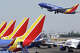 A Southwest Airlines plane takes off from Hollywood Burbank Airport above other Southwest planes on July 25, 2024.