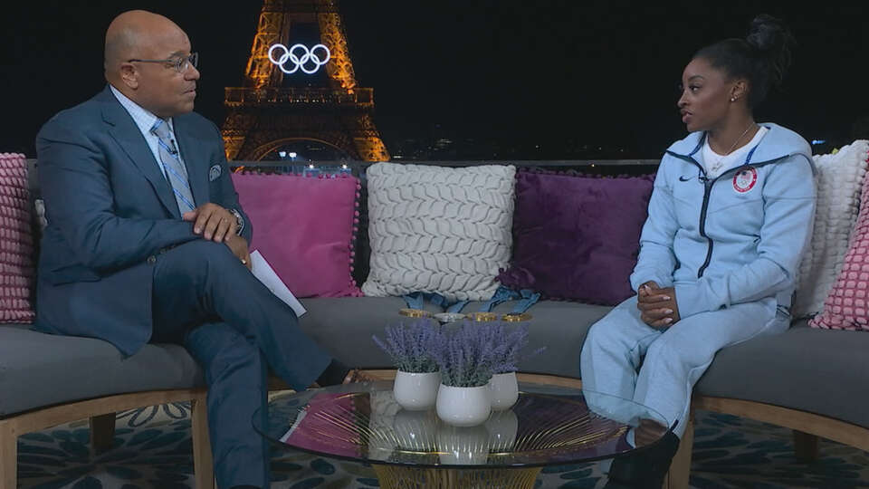 NBC's Mike Tirico, pictured interviewing Simone Biles during the Paris Olympics, said watching the Spring gymnast compete in person is 'the damn most incredible thing you could ever see.'