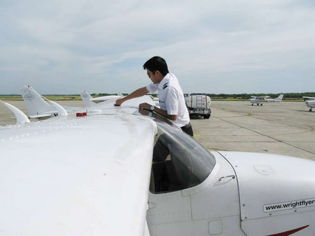 Shuai "Danny" Zhang goes through pre-flight checks on a Cessna before a training flight at Wright Flyers Academy at Hondo Municipal Airport.