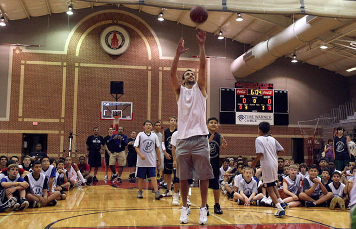 Manu Ginobili takes part in a Spurs youth camp at Incarnate Word, where he said he has focused on fatherhood since the season ended.