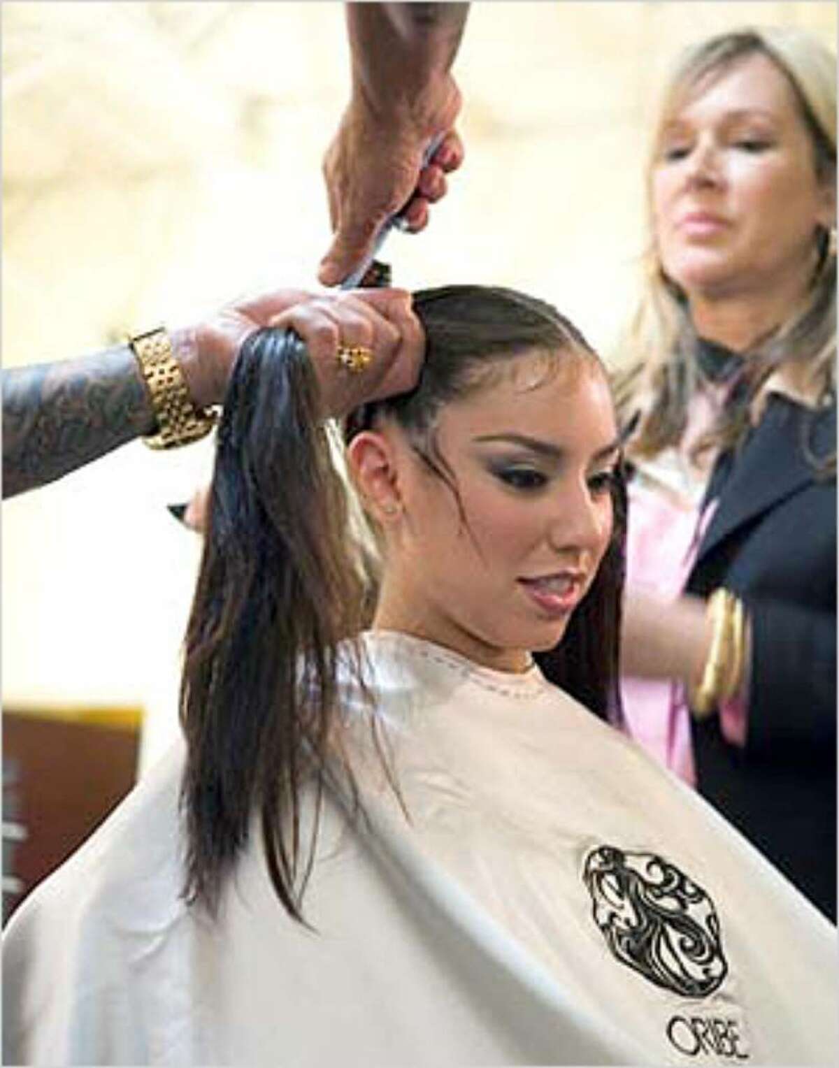 Oribe creates pigtails for the Frida Kahlo look.