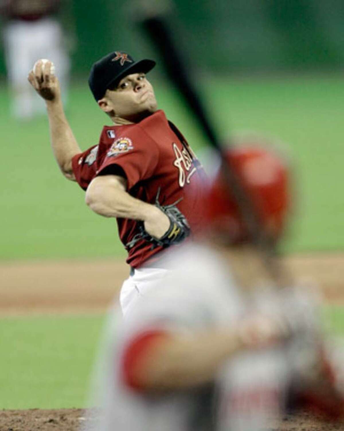 Astros pitcher Wandy Rodriguez (left) delivers a pitch to the Reds' Miguel Cairo during the seventh inning Sunday.