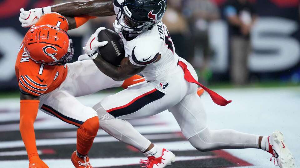 Houston Texans wide receiver Nico Collins (12) scores a 28-yard touchdown against Chicago Bears cornerback Jaylon Johnson (1) during the second quarter of an NFL football game at NRG Stadium, Sunday, Sept. 15, 2024, in Houston.