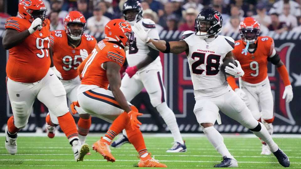 Houston Texans running back Joe Mixon (28) runs the ball against Chicago Bears safety Kevin Byard III (31) during the first quarter of an NFL football game at NRG Stadium, Sunday, Sept. 15, 2024, in Houston.