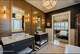 Warm, raised wood paneling adds a rich elegance to this bathroom created by Plum & Crimson Fine Interior Design in Saratoga Springs.