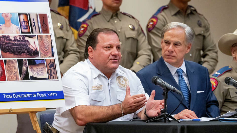 Governor Greg Abbott, left, listens as Texas Border Czar Mike Banks comments on the potential increase of illegal immigration from Venezuela during a press conference at the DPS Southeast Texas Regional Headquarters in Houston.