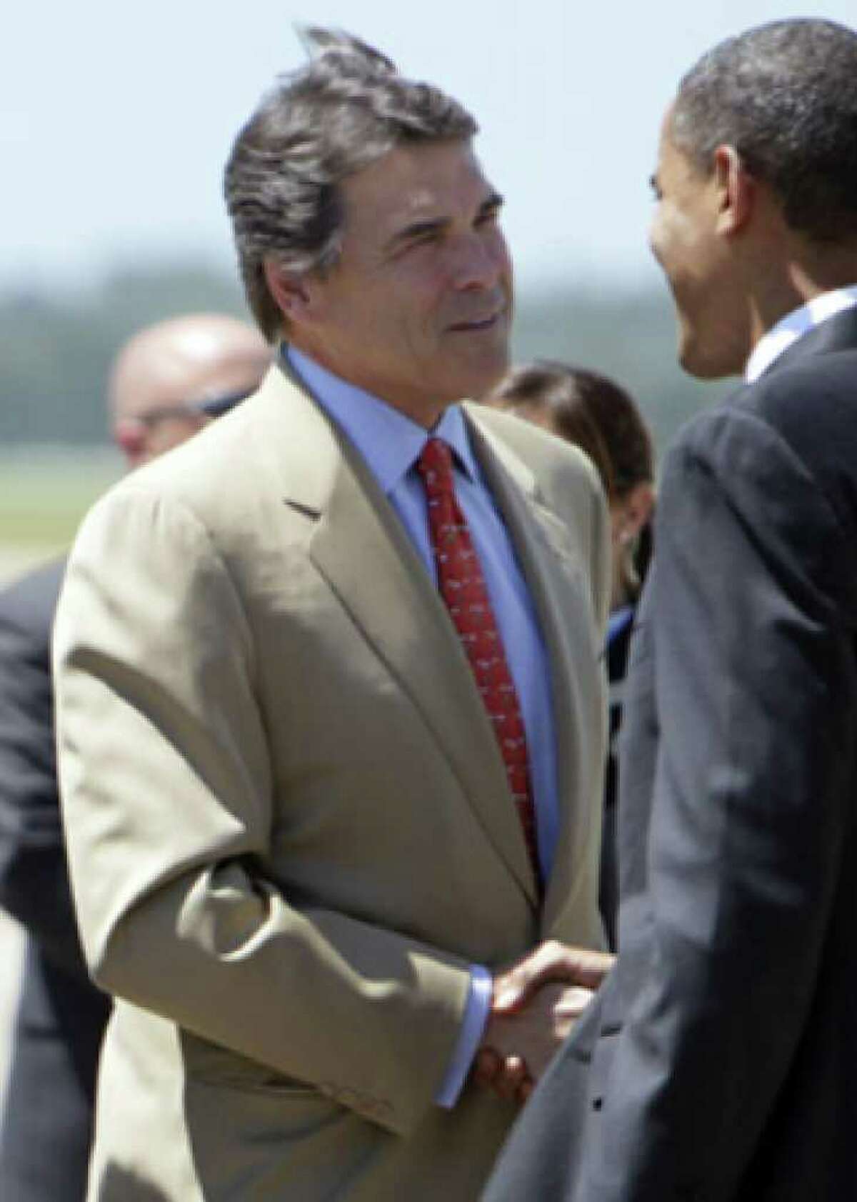 President Barack Obama is greeted Monday by Texas Gov. Rick Perry upon his arrival at Austin Bergstrom International Airport.