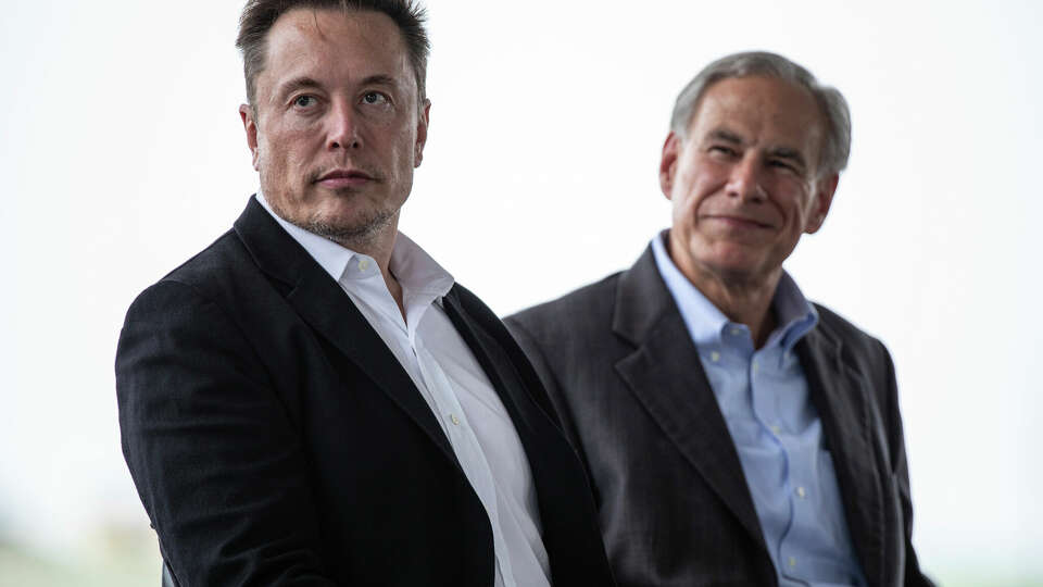 Tesla CEO, Elon Musk, left, sits with Texas Gov. Greg Abbott at a groundbreaking ceremony for the auto manufacturer's lithium refining facility in Robstown, Texas, on Monday, May 8, 2023. 