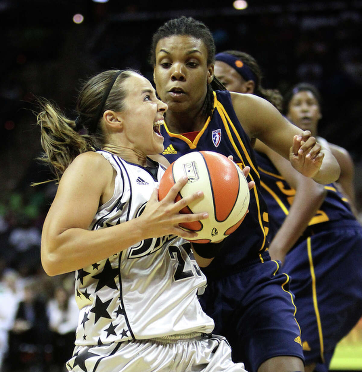 The San Antonio Silver Stars' Becky Hammon (25) drives to the basket against the Connecticut Suns' Tan White (14).