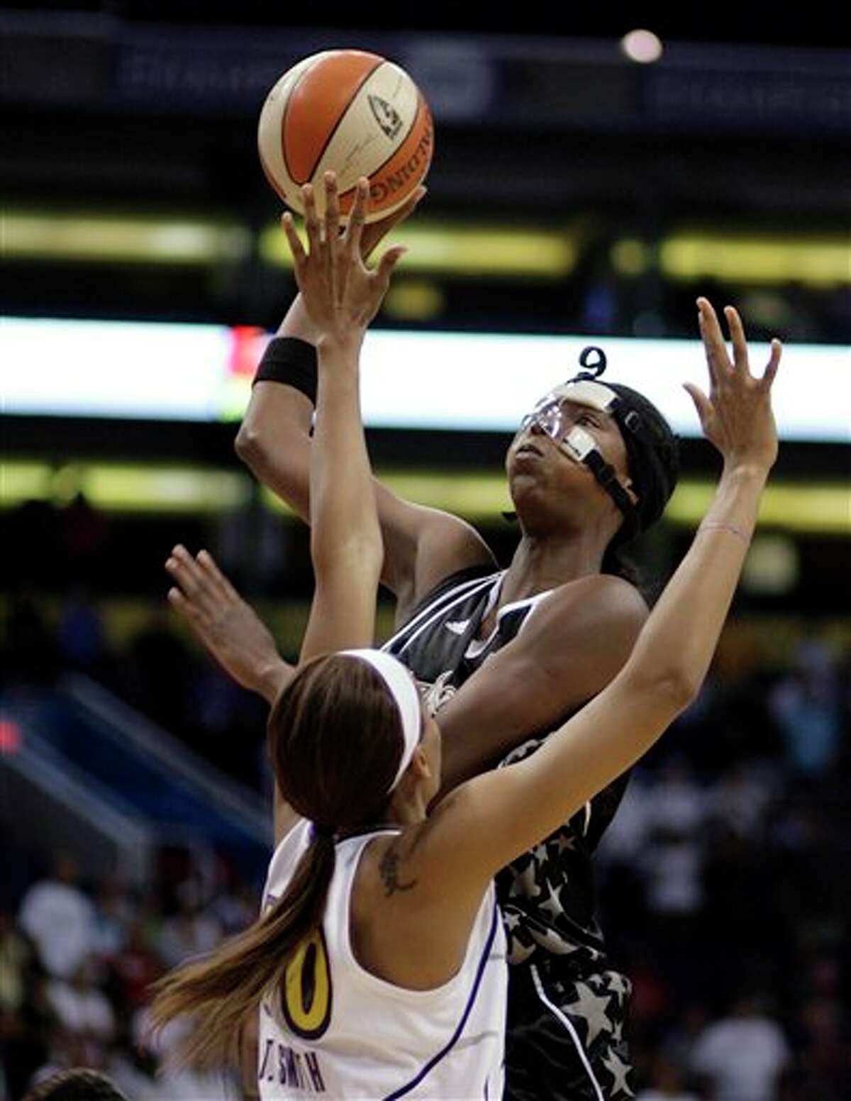 The Silver Stars' Michelle Snow (top) shoots over the Mercury's Tangela Smith.