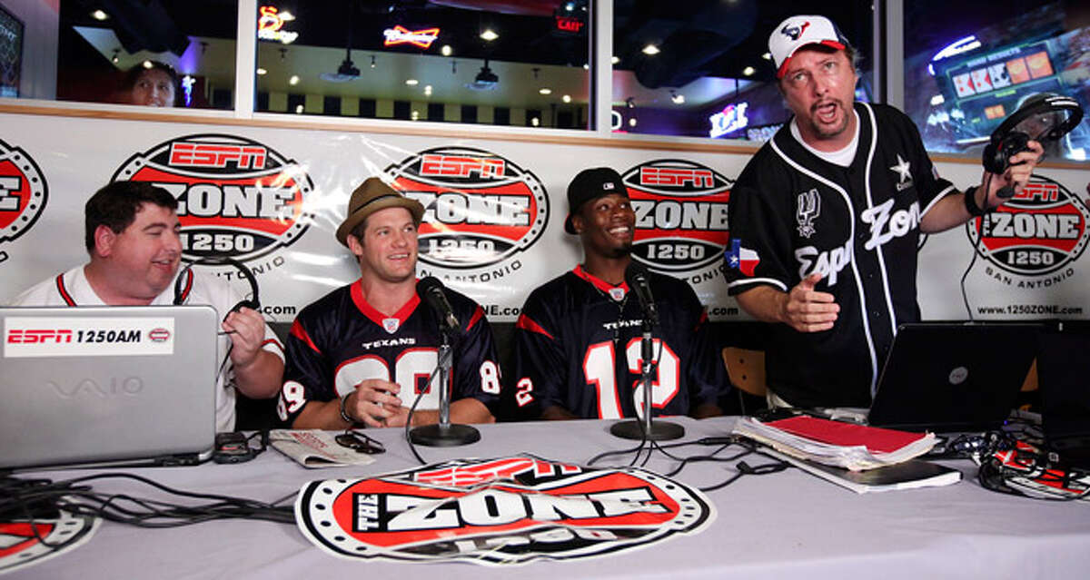 Radio personalities Jason Minnix (left) and Chris Duel (far right) serenade Houston Texans players David Anderson (left center) and Jacoby Jones (right center) Thursday.