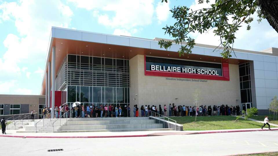 Parents line up to pick up their children in front of Bellaire High School on Wednesday, Sept. 18, 2024, in Bellaire, after the school was placed in a secure mode due to bomb threats.