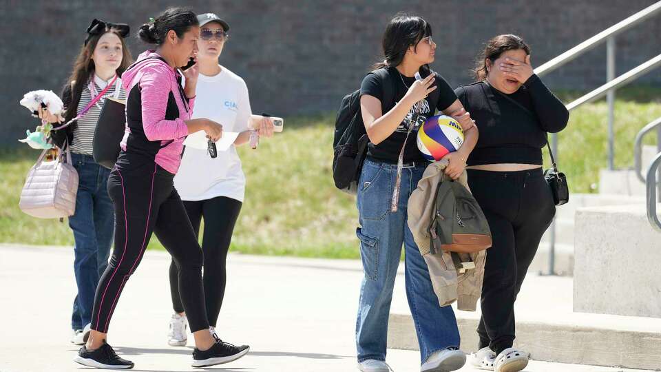 A mother and her daughter walk away from Bellaire High School on Wednesday, Sept. 18, 2024, in Bellaire, after the school was placed in a secure mode due to bomb threats.