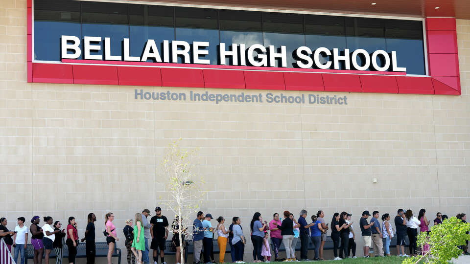 Parents line up to pick up their children in front of Bellaire High School on Wednesday, Sept. 18, 2024, after the school was placed in a secure mode due to bomb threats.