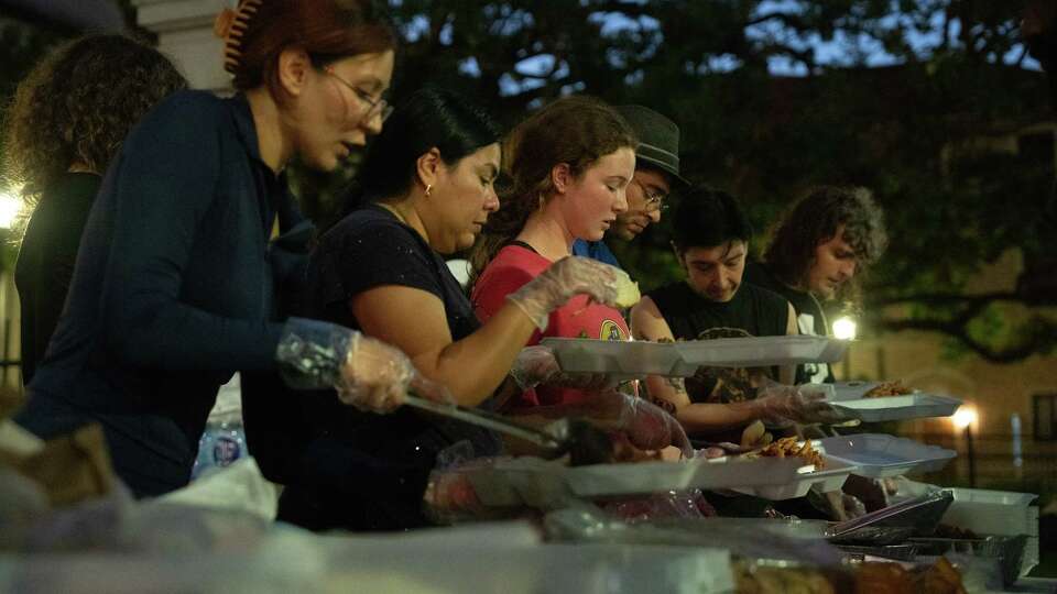 Volunteers with Food Not Bombs pass out meals on Wednesday, Sept. 18, 2024 in Houston.