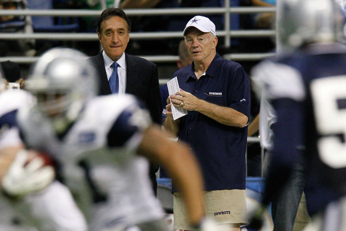 Cowboys owner Jerry Jones, right, talks with Henry Cisneros.
