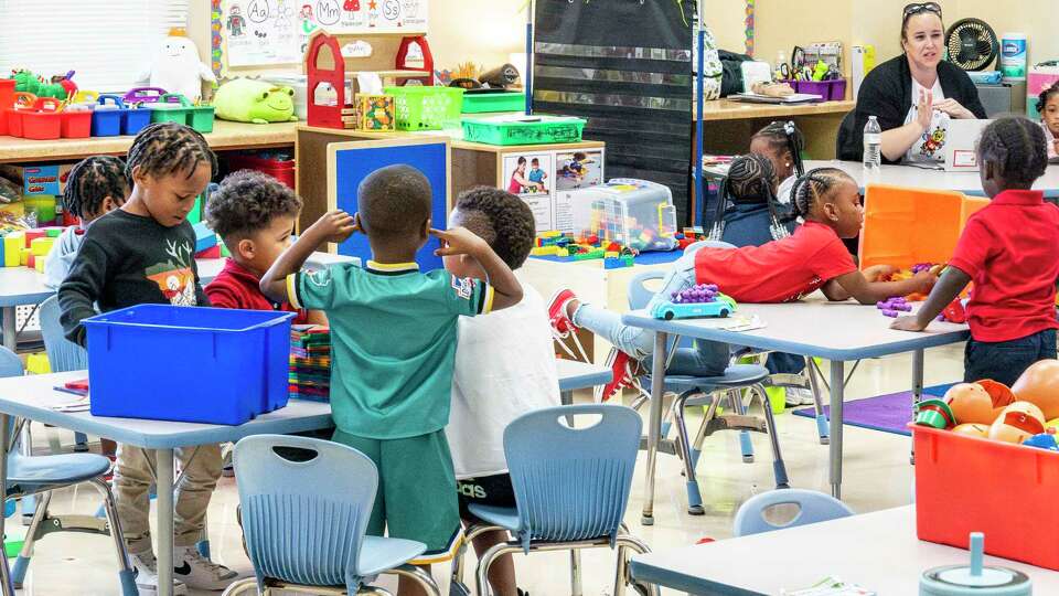 Pre-K students participate in an activity in the classroom of Teri Engleman, upper right, at Highland Heights Elementary School Friday, Sep. 20, 2024 in Houston.