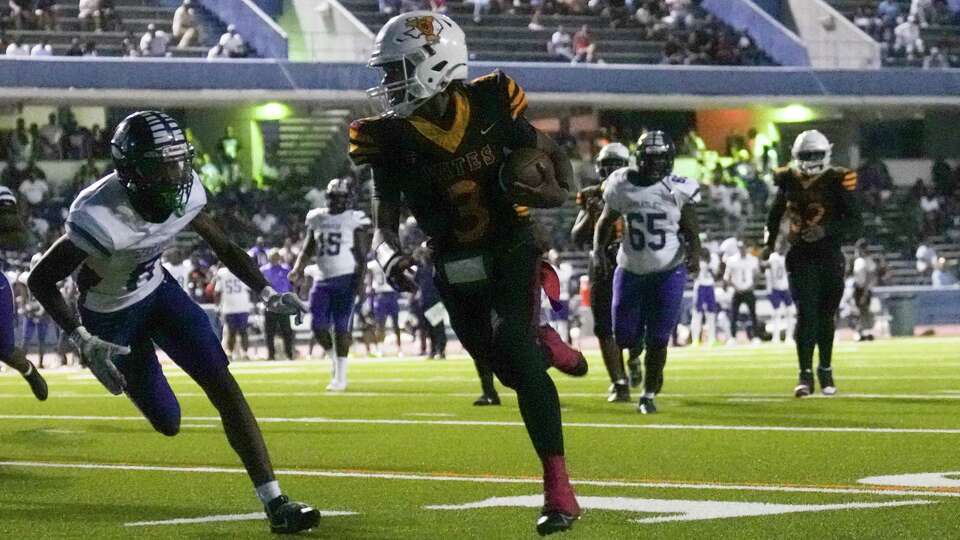 Yates quarterback Christopher Brown (3) runs for a 20-yard touchdown during the second quarter of a District 11-4A high school football game at Barnett Sports Complex, Friday, Sept. 20, 2024, in Houston.