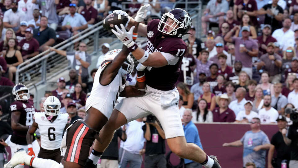 Texas A&M tight end Theo Melin Ohrstrom (17) catches a pass over Bowling Green safety Darius Lorfils (9) in the end zone for a touchdown during the first quarter of an NCAA college football game, Saturday, Sept. 21, 2024, in College Station, Texas. (AP Photo/Sam Craft)