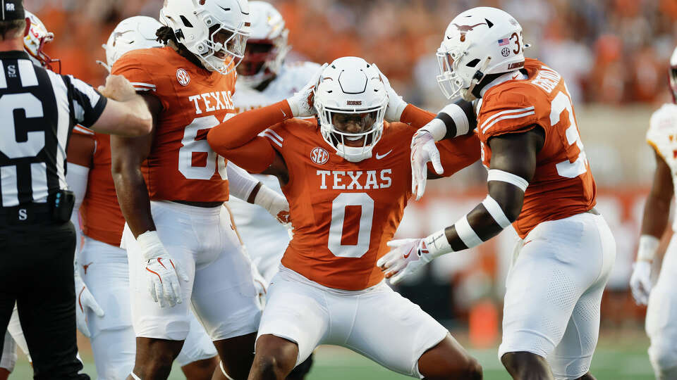 AUSTIN, TEXAS - SEPTEMBER 21: Anthony Hill Jr. #0 of the Texas Longhorns celebrates with David Gbenda #33 and Barryn Sorrell #88 after a sack in the first quarter against the Louisiana Monroe Warhawks at Darrell K Royal-Texas Memorial Stadium on September 21, 2024 in Austin, Texas. (Photo by Tim Warner/Getty Images)