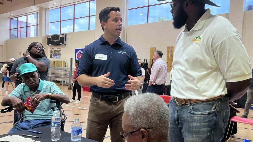 CenterPoint Energy executive Jason Wells talks with residents from northeast Houston during an open house on August 25, 2024 following prolonged outages after Hurricane Beryl.