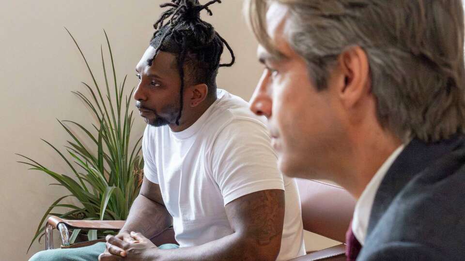 While speaking to media Monday, Sep 24, 2024, in the office of his Houston attorney, Andino Reynal, right, Houston rapper Jeffery Archangel, left, also known by his stage name, Skyler Jones, recalls being arrested and subsequently imprisoned about 4 years before being released in September of 2022.