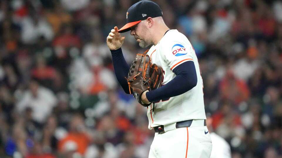 Houston Astros relief pitcher Ryan Pressly (55) reacts between pitches during the eighth inning of an MLB baseball game at Minute Maid Park on Tuesday, Sept. 24, 2024, in Houston.