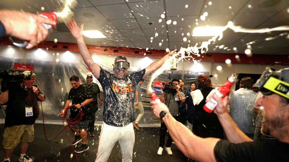 Houston Astros pitcher Justin Verlander is showered with champagne and beer as they celebrated in the clubhouse after winning the American League West title after beating the Seattle Mariners 4-3 after an MLB baseball game at Minute Maid Park on Tuesday, Sept. 24, 2024, in Houston.