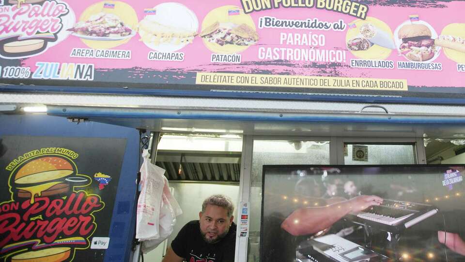 Eugenio Velazco chats outside the window of Don Pollo Burgers food truck near World Theater on Tuesday, Sept. 24, 2024 in Katy. The established Venezuelan coming in Katy has changed in recent years with the increased of immigrants from the country.