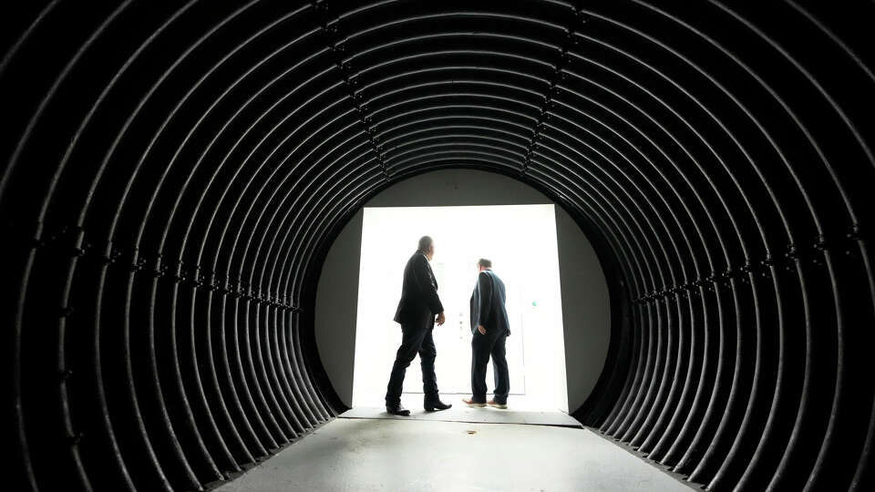 Ronald Bailey, technical advisor, left, and Todd M. Smith, commercial advisor, walk through one of the underground tunnel connections at the Westland Bunker, an underground data center facility in Montgomery. 