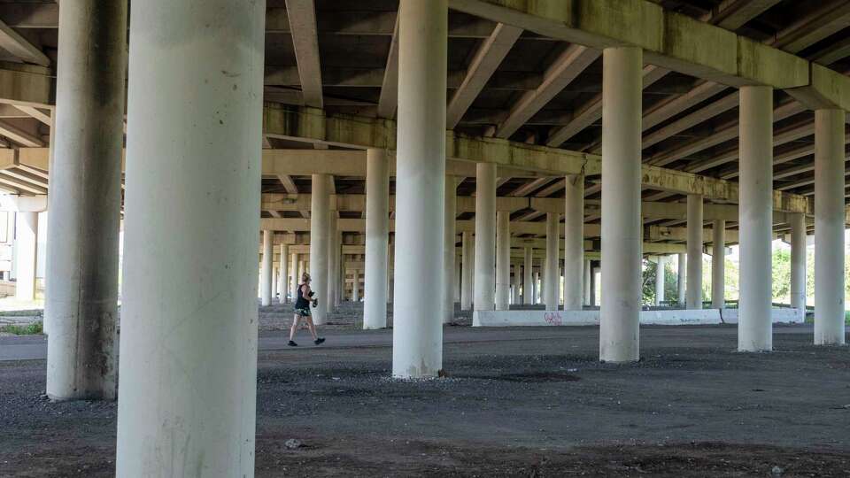 A hiker traverses the MKT Trail underneath Interstate 10 Thursday, Sep. 26, 2024, near Studemont Street where the area underneath I10 could potentially be converted to usable space along the hike and bike route in Houston.