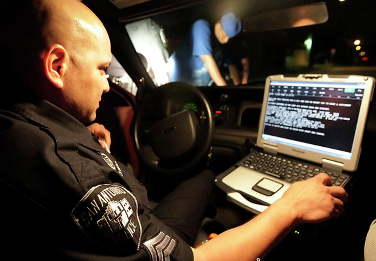 Sgt. Tom Alonzo does a background check from his in-car computer as part of the Police Department's Problem Oriented Policing unit. The new POP program also includes representatives from a number of other city services.