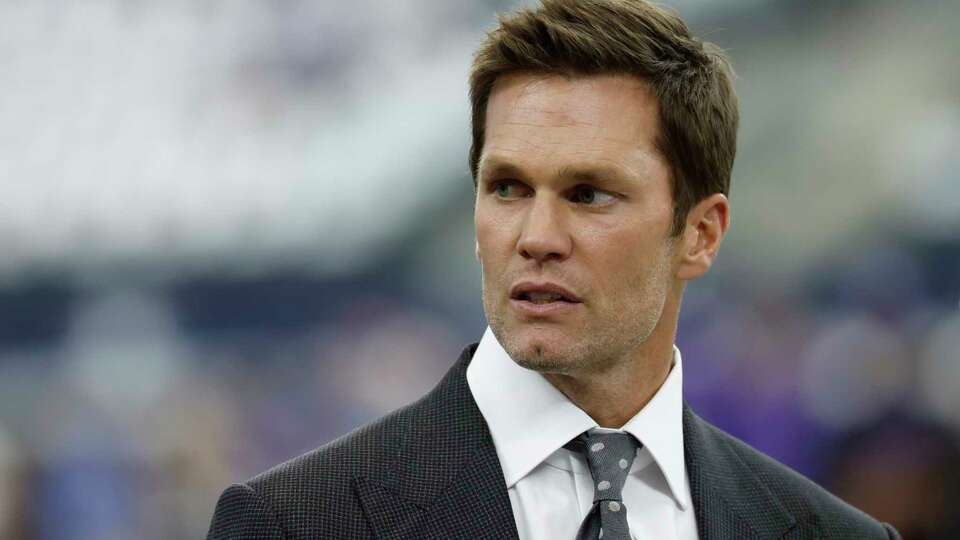 Fox announcer Tom Brady during pregame warmups before an NFL football game between the Baltimore Ravens the Dallas Cowboys on Sunday, Sept. 22, 2024, in Arlington, Texas. (AP Photo/Matt Patterson)