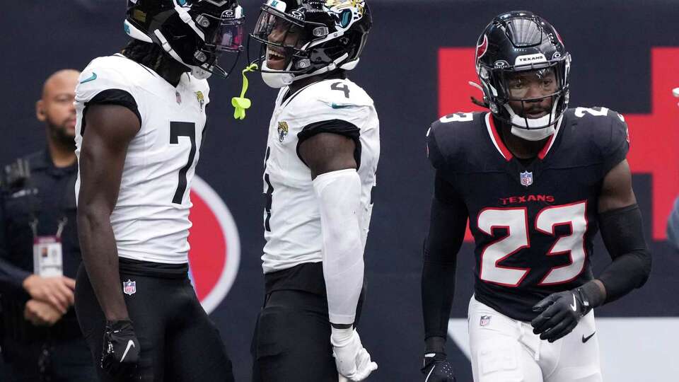 Houston Texans safety Eric Murray, right, is seen as Jacksonville Jaguars running back Tank Bigsby, left, celebrates wide receiver Brian Thomas Jr.’s 2-yard touchdown pass during the first half of an NFL football game Sunday, Sept. 29, 2024, in Houston.