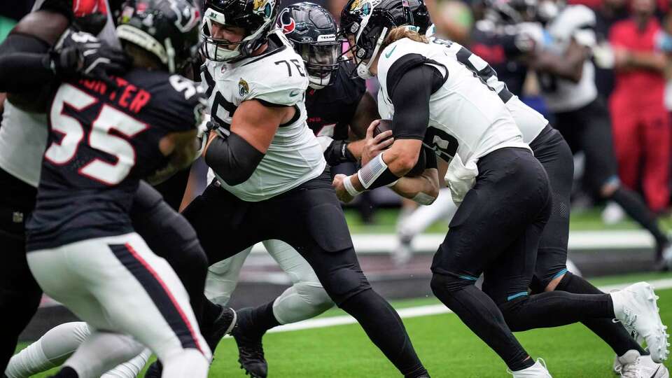 Jacksonville Jaguars quarterback Trevor Lawrence (16) runs into the center of the line on 4th and goal and is stopped by Houston Texans defensive tackle Folorunso Fatukasi (91) during the second half of an NFL football game Sunday, Sept. 29, 2024, in Houston. The Texans took over on downs.