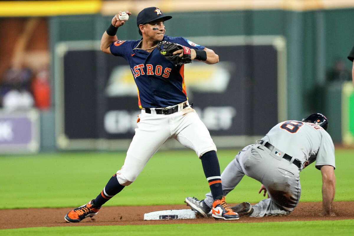 Houston Astros second baseman Mauricio Dubon (14) throws over Detroit Tigers center fielder Matt Vierling (8) after forcing him out at second during the first inning of a Major League Baseball game on Tuesday, April 4, 2023, in Houston.