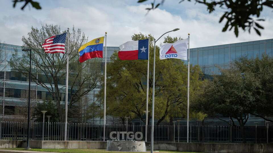 Flags fly outside Citgo Petroleum Corp. headquarters stands in Houston on Feb. 14, 2019. MUST CREDIT: Bloomberg photo by Loren Elliot.