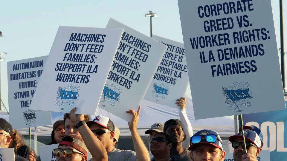 Longshoremen carry signs and chant Tuesday, Oct. 1, 2024, outside the Bayport Container Terminal in Seabrook as members of the International Longshoreman’s Association have decided to strike after their contract expired at midnight. ( Kirk Sides / Houston Chronicle )