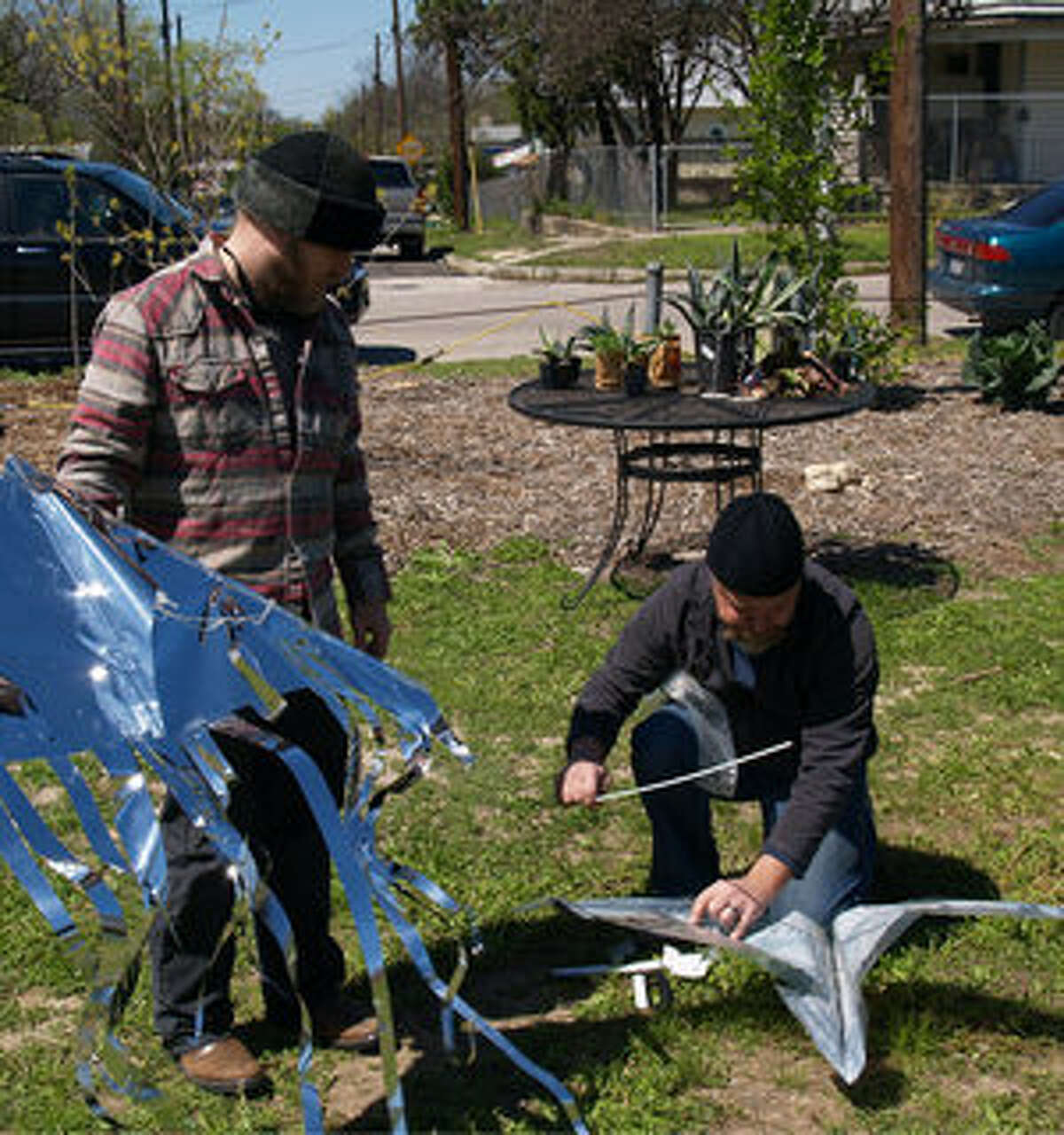 Chris Sauter and Rick Frederick assemble their kites at the Kite Festival at Pittman-Sullivan Park.