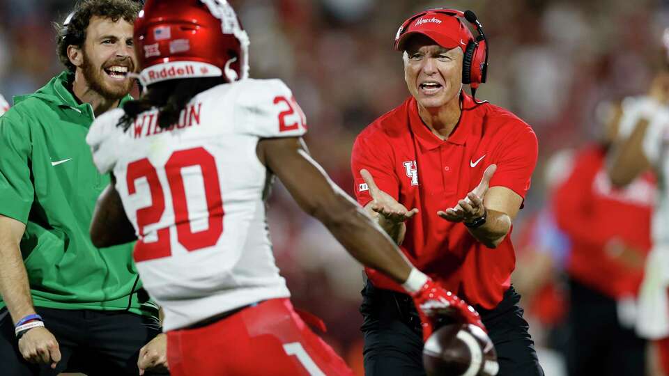 Houston head coach Willie Fritz, right, reacts after Houston defensive back Jeremiah Wilson (20) intercepted a pass by Oklahoma during the second half of an NCAA college football game Saturday, Sept. 7, 2024, in Norman, Okla. (AP Photo/Alonzo Adams)