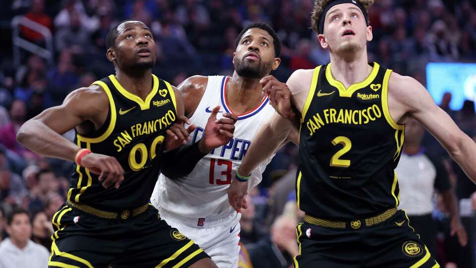 Golden State Warriors’ Jonathan Kuminga and Brandin Podziemski box out Los Angeles Clippers’ Paul George in 2nd quarter during NBA game at Chase Center in San Francisco on Wednesday, February 14, 2024.