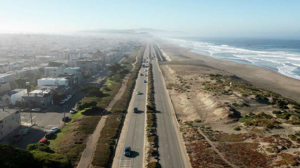 Vehicles during the morning commute drive on the Great Highway next to Ocean Beach in San Francisco on Friday, Sept. 27, 2024. Voters will decide the future of the two-mile stretch in November. Proposition K would ban private vehicles on the Upper Great Highway between Lincoln Way and Sloat Boulevard. The road has been closed intermittently to traffic on a trial basis, making the road accessible to foot traffic.